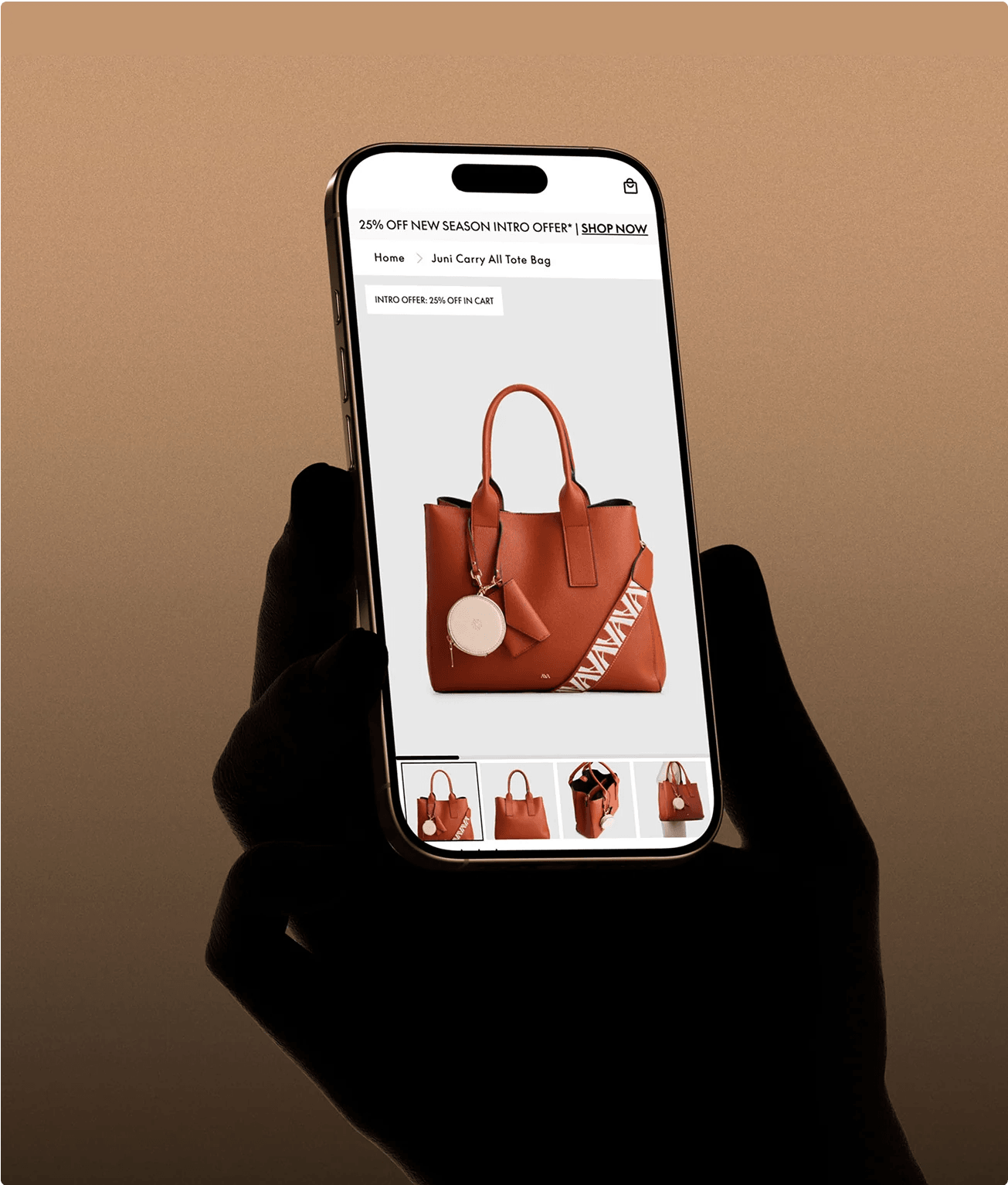 Shopper holding a phone on Strand's Juni Carry All tote bag product page